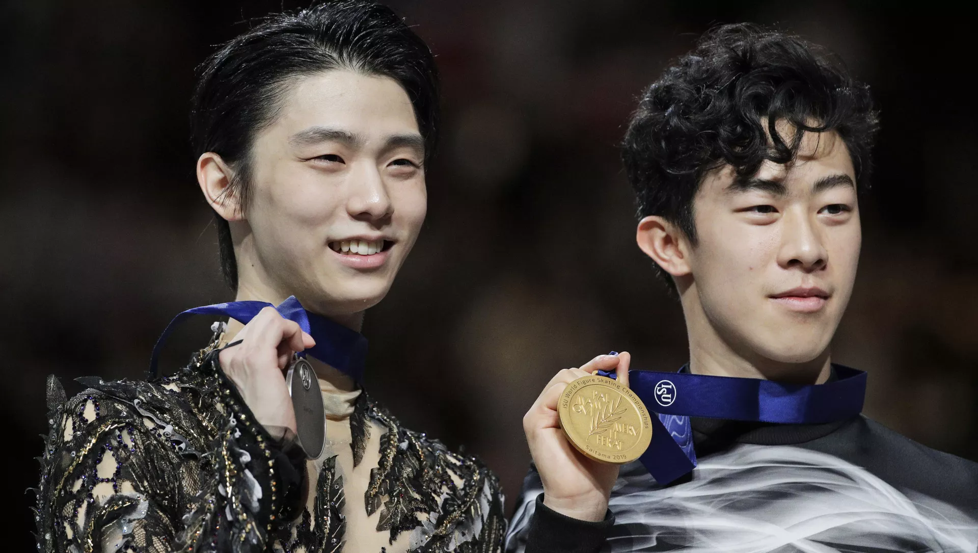 Japan's Yuzuru Hanyu and Nathan Chen from the U.S. display their silver and gold medals respectively during the men's free skating routine during the ISU World Figure Skating Championships at Saitama Super Arena in Saitama, north of Tokyo, Saturday, March 23, 2019. 