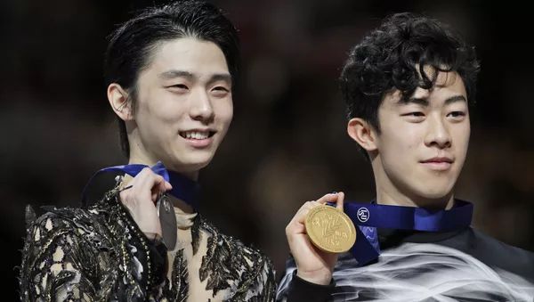 Japan's Yuzuru Hanyu and Nathan Chen from the U.S. display their silver and gold medals respectively during the men's free skating routine during the ISU World Figure Skating Championships at Saitama Super Arena in Saitama, north of Tokyo, Saturday, March 23, 2019. 