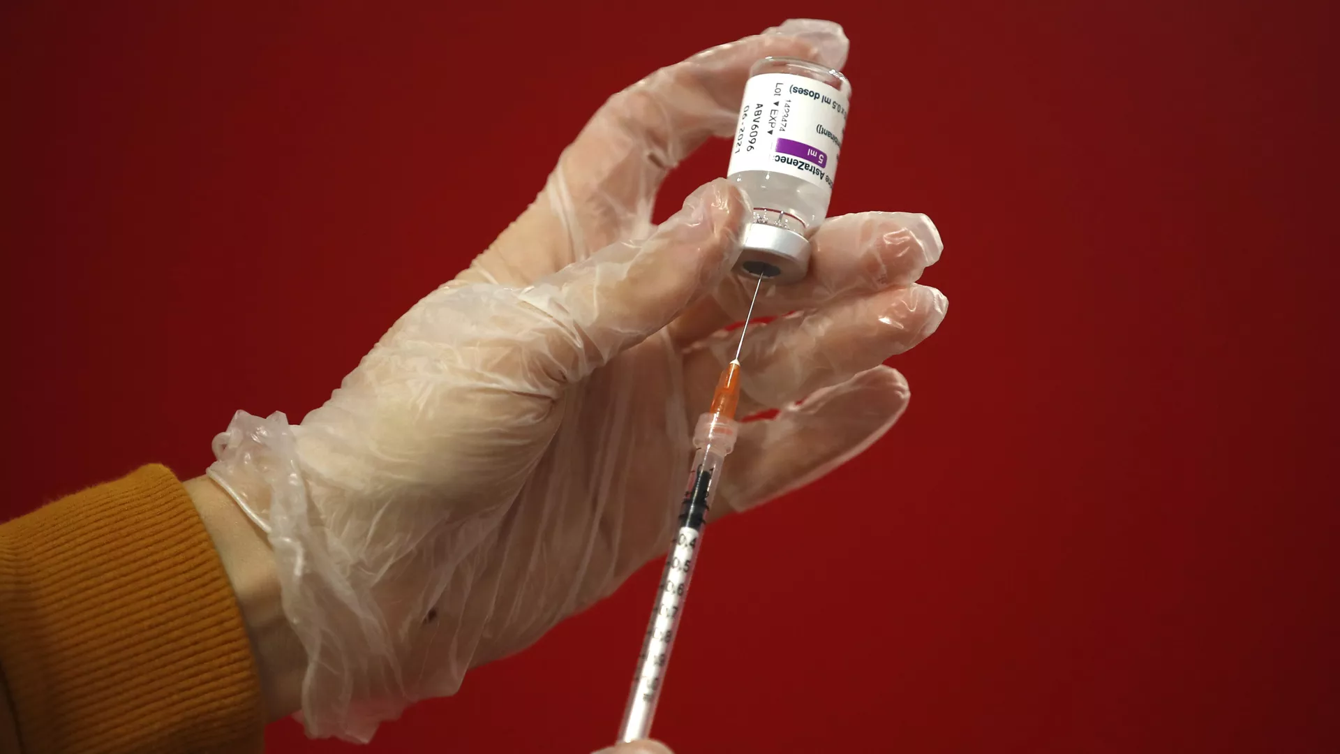 A health worker shows the media how she prepares a dose of the AstraZeneca vaccine to be administered to a patient at a vaccination center set up in front of Rome's Termini central station, Monday, March 8, 2021