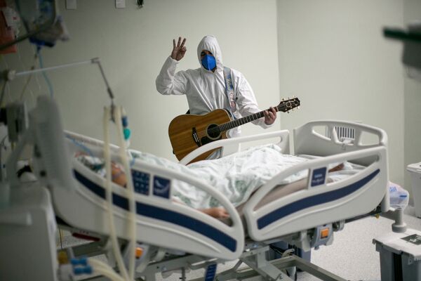 ブラジル・パラー州ベレンの慈善病院で、イースターのお祝いで新型コロナウイルス患者にギターの弾き語りをする医療従事者 - Sputnik 日本