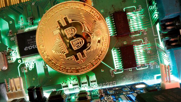 Representation of the virtual currency Bitcoin is seen on a motherboard in this picture illustration taken April 24, 2020 - Sputnik 日本