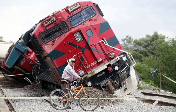 メメキシコ・ハリスコ州で脱線した列車の横を自転車で通り過ぎる男性 - Sputnik 日本