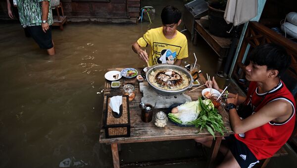 タイ中部・ノンタブリー県で、水浸しになったレストラン「Chaopraya Antique」で食事をする人々 - Sputnik 日本