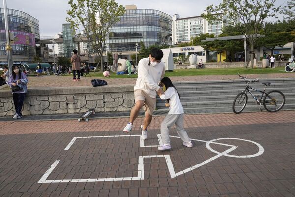 韓国・京畿道高陽（コヤン）市の公園で、『イカゲーム』劇中で行われたゲーム「イカゲーム」を遊ぶ親子 - Sputnik 日本
