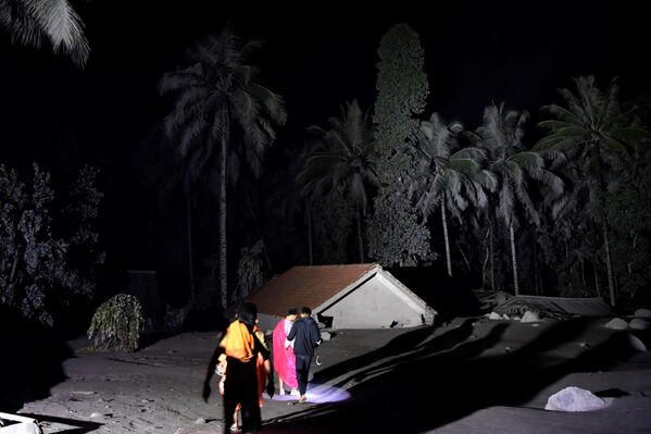 セメル山から噴出した火山灰に埋もれた住宅近くを歩く住民ら（インドネシア・ルマジャン県、5日） - Sputnik 日本