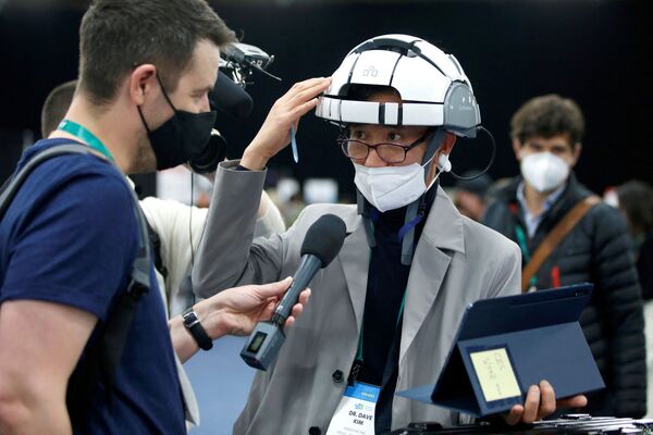 CES 2022の公式メディアイベント「CES Unveiled」で、健康状態をモニタリングするセラピーヘルメットをかぶる参加者（3日、米ネバダ州・ラスベガス） - Sputnik 日本