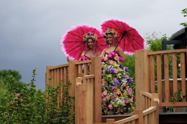 王立園芸協会で開催されるチェルシー・フラワー・ショー プレスデーのプレスデーで、花をあしらったドレス姿でプロモーション活動を行う女性（英ロンドン、23日） - Sputnik 日本