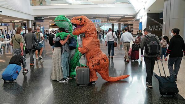 国際空港で、恐竜の着ぐるみ姿で友人を出迎える人々（米ユタ州・ソルトレイクシティ、27日） - Sputnik 日本