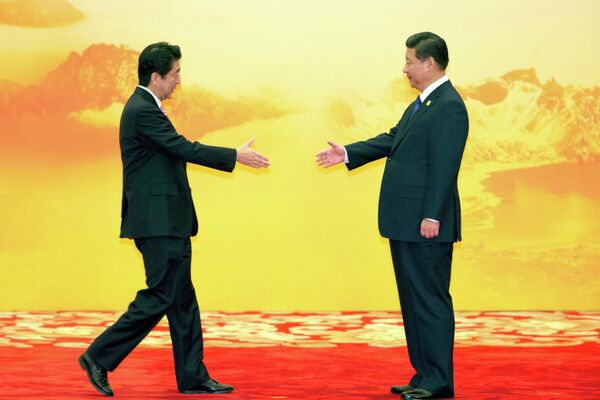 APEC首脳会議の歓迎式典で中国の習近平国家主席へ握手のため手を伸ばす安倍晋三元首相（中国・北京、2014年11月11日） - Sputnik 日本