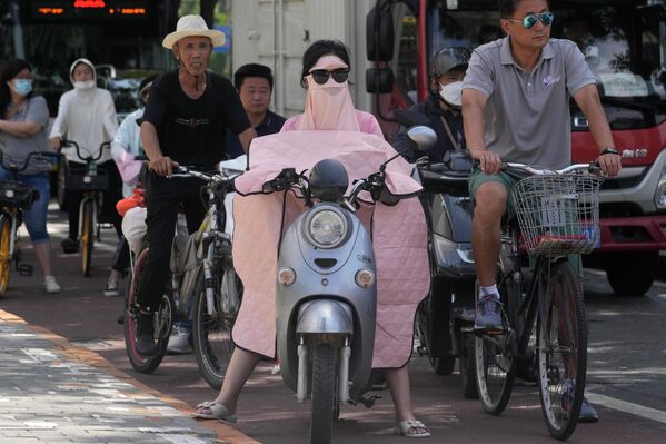 日よけコートを着てバイクを運転する女性（中国・北京、22日） - Sputnik 日本
