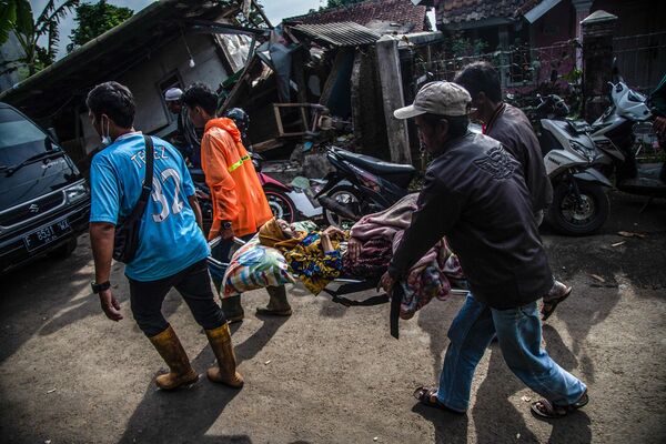地震で負傷した女性を運ぶ住民ら（インドネシア・チアンジュール県、22日） - Sputnik 日本