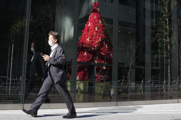 1. ビジネスセンター内部に飾られたツリーの前を通り過ぎる人。東京。 - Sputnik 日本
