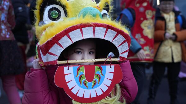 英ロンドンで行われた旧正月を祝うパレードで、龍を模した被りものを被る少女（22日） - Sputnik 日本