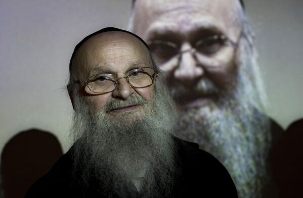 壁に映し出された自分の姿とともに撮影に応じるホロコースト生存者のアレックス・サイデンフェルドさん（当時82）（イスラエル・エルサレム、2012年1月） - Sputnik 日本