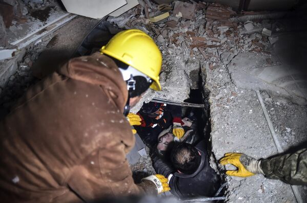 倒壊した建物の瓦礫から女性を救出する救急隊員（トルコ・カフラマンマラシュ県エルビスタン、7日） - Sputnik 日本