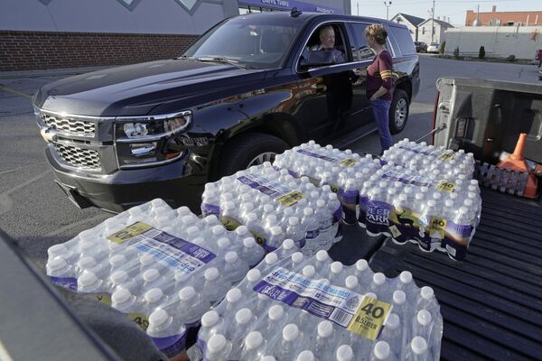 貨物列車脱線事故後の清掃作業が続く中、水を配る女性（オハイオ州イーストパレスティーン、15日） - Sputnik 日本