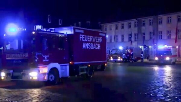 In this image taken from video fire trucks and ambulances stand in the city center of Ansbach near Nuremberg, southern Germany, Monday morning, July 25, 2016, after a man was killed when an explosive device he was believed to be carrying went off near an open-air music festival, injuring 12 others. - Sputnik 日本