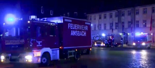 In this image taken from video fire trucks and ambulances stand in the city center of Ansbach near Nuremberg, southern Germany, Monday morning, July 25, 2016, after a man was killed when an explosive device he was believed to be carrying went off near an open-air music festival, injuring 12 others. In this image taken from video fire trucks and ambulances stand in the city center of Ansbach near Nuremberg, southern Germany, Monday morning, July 25, 2016, after a man was killed when an explosive device he was believed to be carrying went off near an open-air music festival, injuring 12 others. - Sputnik 日本