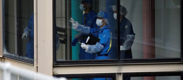 Police officers investigate at a facility for the disabled, where a deadly attack by a knife-wielding man took place, in Sagamihara, Kanagawa prefecture, Japan, July 26, 2016. - Sputnik 日本