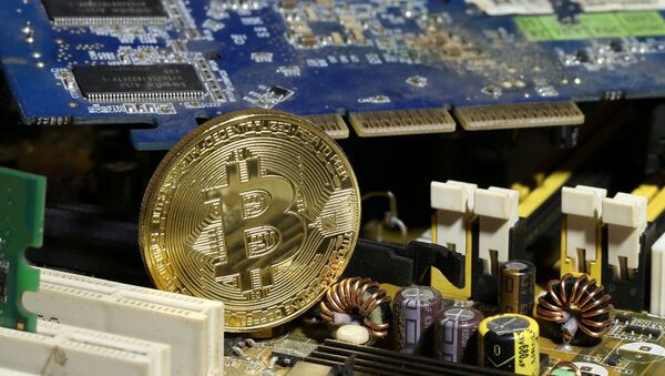 A copy of bitcoin standing on PC motherboard is seen in this illustration picture, October 26, 2017 - Sputnik 日本