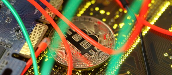 Representation of the Bitcoin virtual currency standing on the PC motherboard is seen in this illustration picture, February 3, 2018 Representation of the Bitcoin virtual currency standing on the PC motherboard is seen in this illustration picture, February 3, 2018 - Sputnik 日本