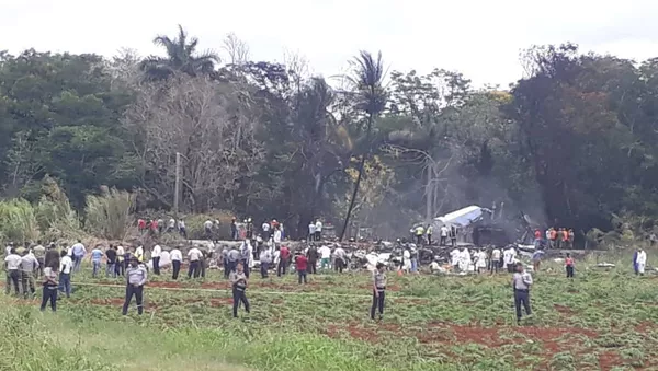 Rescue and search workers on the site where a Cuban airliner with 104 passengers on board plummeted into a yuca field just after takeoff from the international airport in Havana, Cuba, Friday, May 18, 2018.