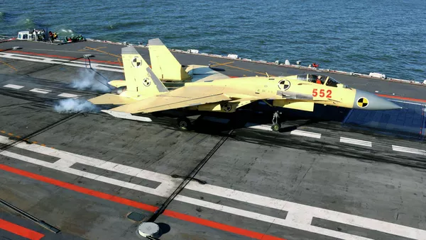 In this undated photo released by China's Xinhua News Agency, a carrier-borne J-15 fighter jet lands on China's first aircraft carrier, the Liaoning