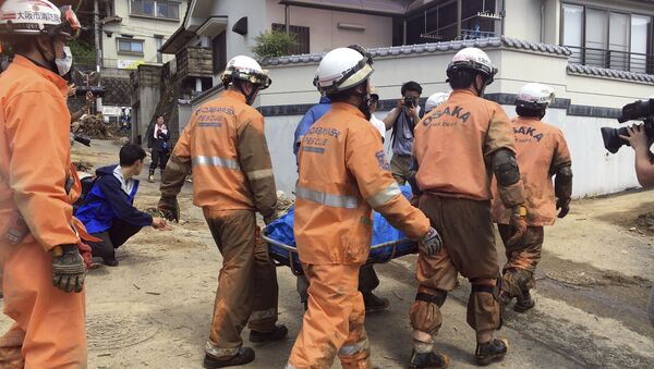 Спасатели выносят тело жертвы, погибшей во время сильных ливней в Хиросиме, Япония - Sputnik 日本