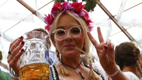 A visitor drinks beer on the first day of the 182nd Oktoberfest in Munich, Germany, September 19, 2015