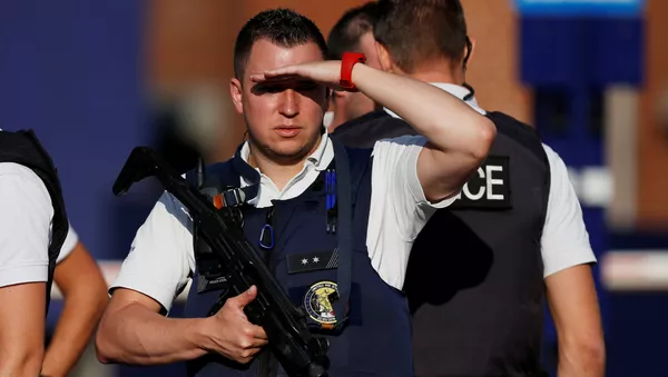 Belgian police officers stand guard outside the main police station