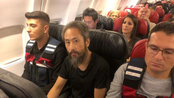 Японский журналист Дзюмпэй Ясуда сидит в самолете между турецкими жандармами на рейсе из Стамбула в аэропорт Хатай, Турция - Sputnik 日本