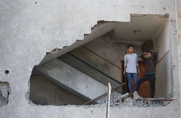イスラエルによるガザ地区への攻撃の被害を受けた住宅の中の若者たち - Sputnik 日本