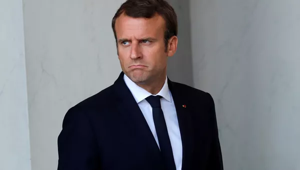 French President Emmanuel Macron walks back to his office after a meeting with guests at the Elysee Palace in Paris, France, August 31, 2017