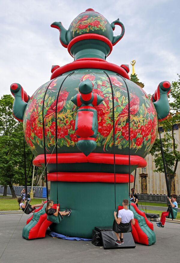巨大なロシアの湯沸かし器「サモワール」につけられたブランコに乗る子どもたち、モスクワで開催されたロシア文化フェスティバルにて - Sputnik 日本
