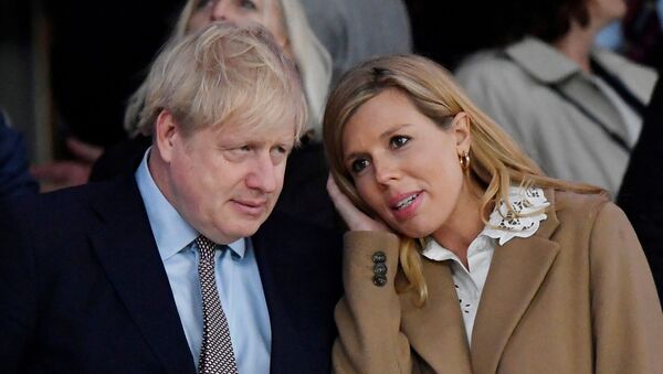 Rugby Union - Six Nations Championship - England v Wales - Twickenham Stadium, London, Britain - March 7, 2020  Britain's Prime Minister Boris Johnson with his partner Carrie Symonds after the match - Sputnik 日本