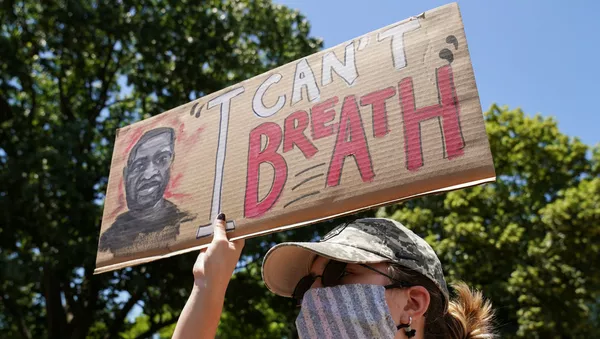A woman holds up a sign near the White House to protest over the death in Minneapolis police custody of George Floyd in Washington, U.S., June 1, 2020